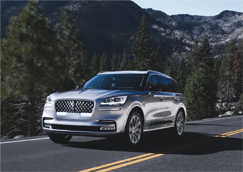 A 2023 Lincoln Aviator® Grand Touring SUV being driven on a winding road to demonstrate the capabilities of all-wheel drive | Magic City Lincoln in Roanoke VA
