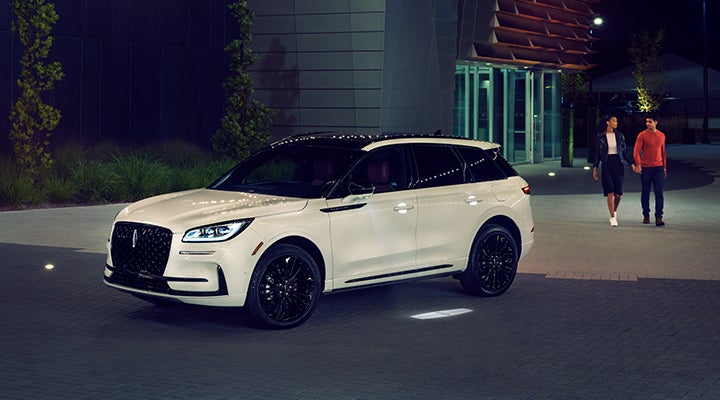 Two people approach a 2024 Lincoln Corsair® SUV featuring the available Jet Appearance Package. | Magic City Lincoln in Roanoke VA