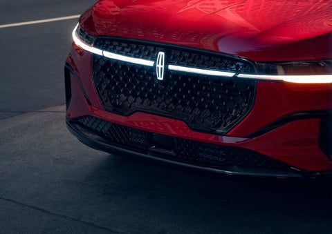 The available front LED light bar and center Lincoln Star logo glow at dusk. | Magic City Lincoln in Roanoke VA