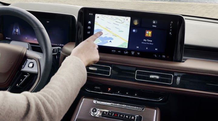 A person is tapping the center display touchscreen of a 2026 Lincoln Aviator® SUV. | Magic City Lincoln in Roanoke VA