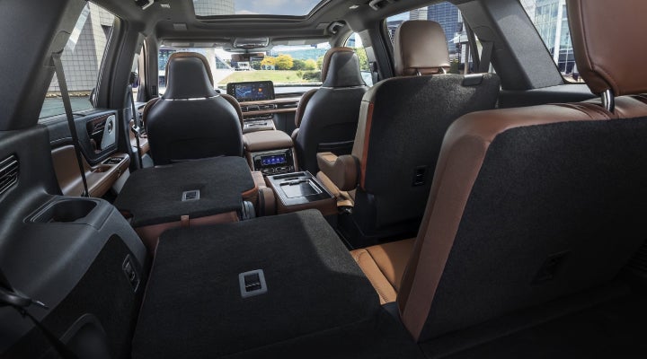 One side of the PowerFold® third-row seat and a second-row seat are folded forward in the 2026 Lincoln Aviator® SUV. | Magic City Lincoln in Roanoke VA
