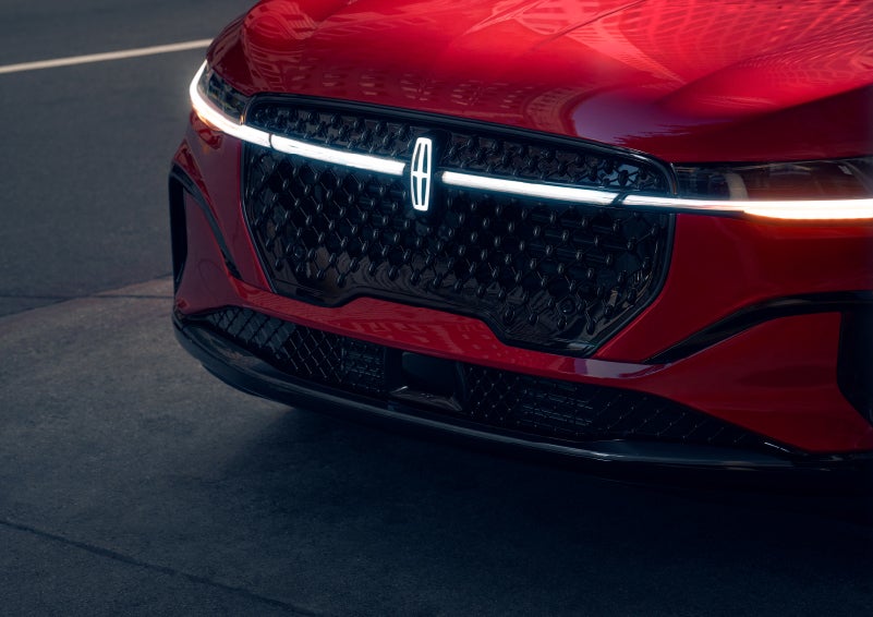 The available front LED light bar and center Lincoln Star logo glow at dusk. | Magic City Lincoln in Roanoke VA