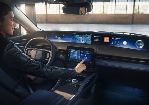 The driver of a 2026 Lincoln Nautilus® SUV interacts with the center touchscreen. | Magic City Lincoln in Roanoke VA