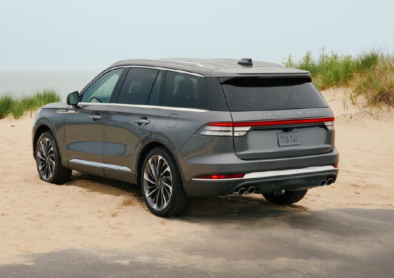 A 2027 Lincoln Aviator® SUV is parked next to sand dunes. | Magic City Lincoln in Roanoke VA