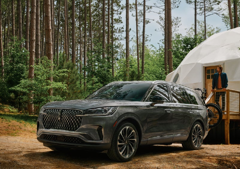 A 2027 Lincoln Aviator® is parked next to a high end glamping site. | Magic City Lincoln in Roanoke VA