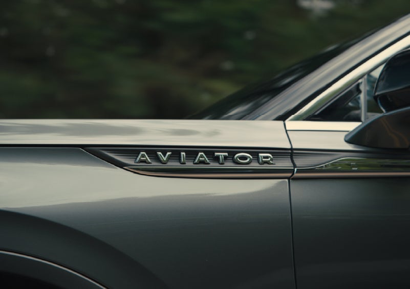 The driver’s side door and fender badging of a gray 2027 Lincoln Aviator® SUV are showcased. | Magic City Lincoln in Roanoke VA