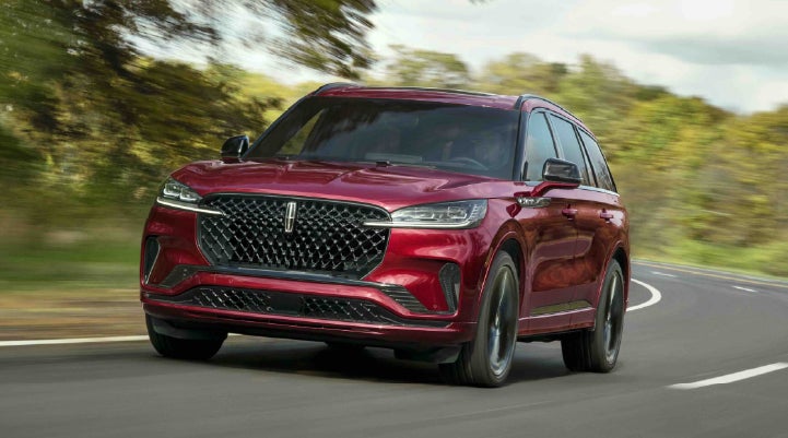 A 2027 Lincoln Aviator® SUV is being driven on a country road | Magic City Lincoln in Roanoke VA