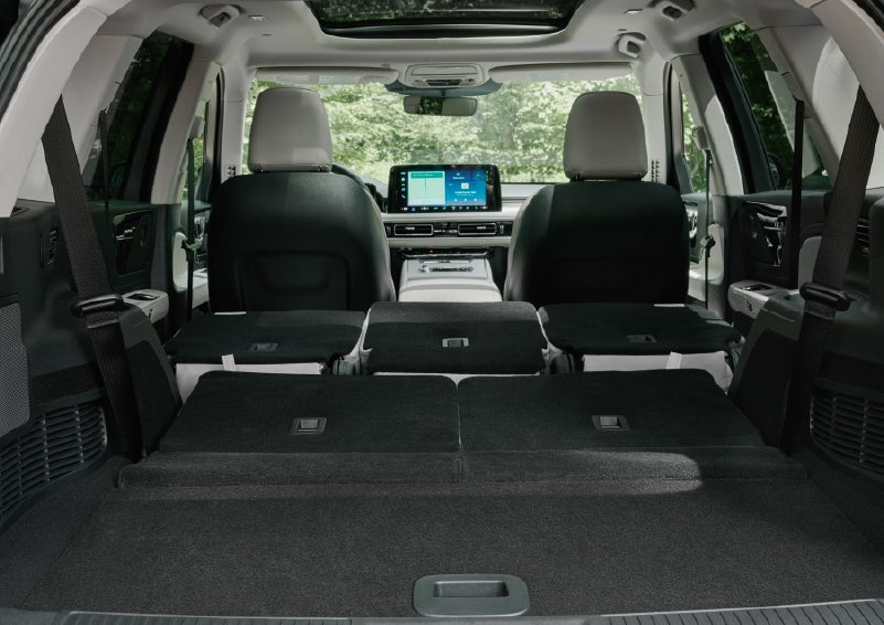 A rear to front view of the interior of a 2027 Lincoln Aviator® Black Label™ SUV shows the third and second rows folded flat | Magic City Lincoln in Roanoke VA