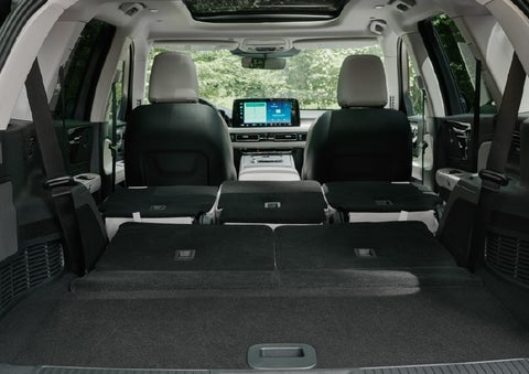 A rear to front view of the interior of a 2027 Lincoln Aviator® Black Label™ SUV shows the third and second rows folded flat | Magic City Lincoln in Roanoke VA