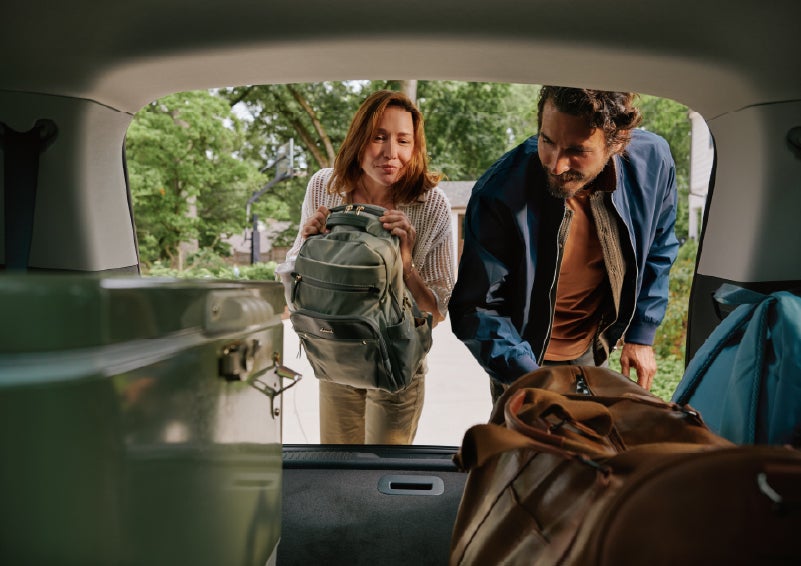 A couple loads luggage into the rear of a 2027 Lincoln Aviator® Black Label™ SUV..e 202 | Magic City Lincoln in Roanoke VA